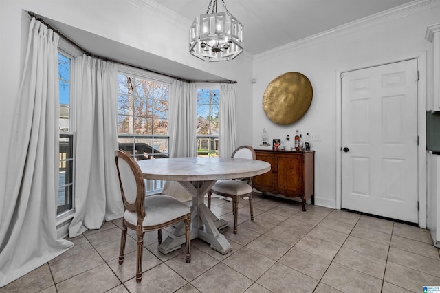 tiled dining area featuring a notable chandelier and crown molding