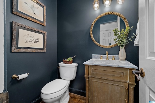 bathroom featuring vanity, toilet, and wood-type flooring