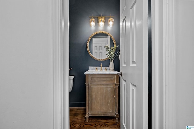 bathroom with vanity, hardwood / wood-style flooring, and toilet