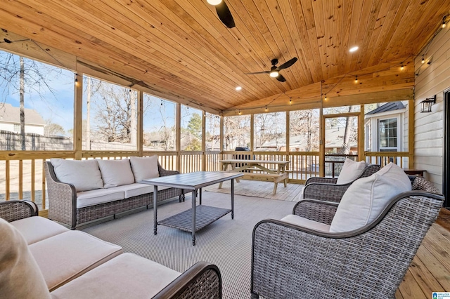 sunroom / solarium featuring lofted ceiling, wood ceiling, and ceiling fan