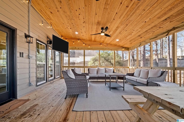 sunroom / solarium with ceiling fan, lofted ceiling, and wooden ceiling