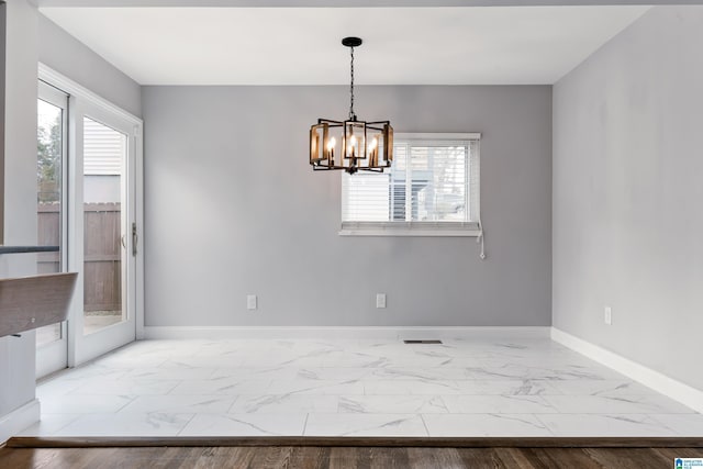 unfurnished dining area with a notable chandelier