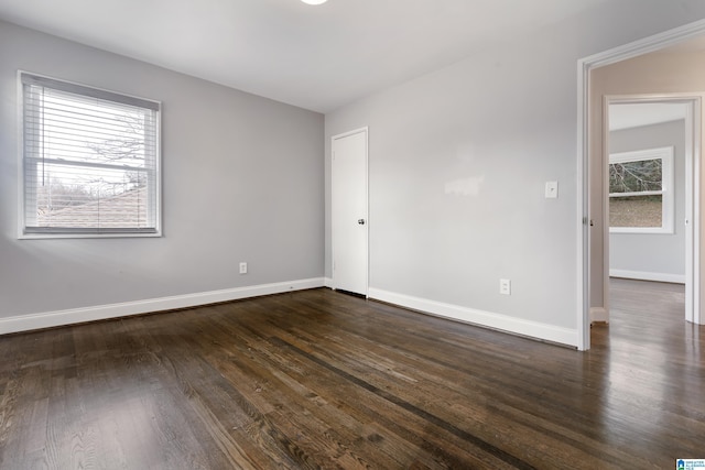 spare room with dark wood-type flooring