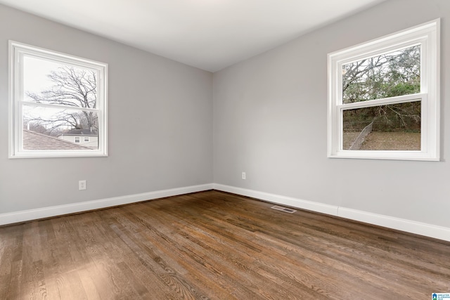 empty room with hardwood / wood-style floors