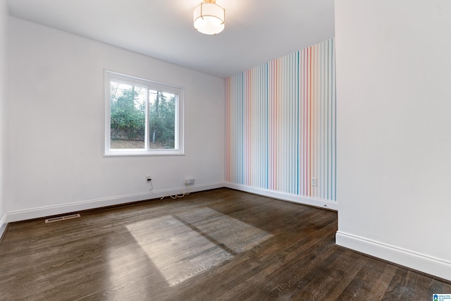 empty room with dark hardwood / wood-style floors