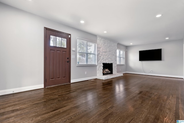 unfurnished living room with dark hardwood / wood-style floors and a fireplace