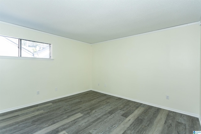 empty room featuring dark wood-type flooring, ornamental molding, and a textured ceiling