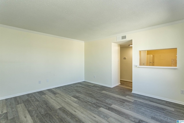 spare room with dark wood-type flooring, ornamental molding, and a textured ceiling