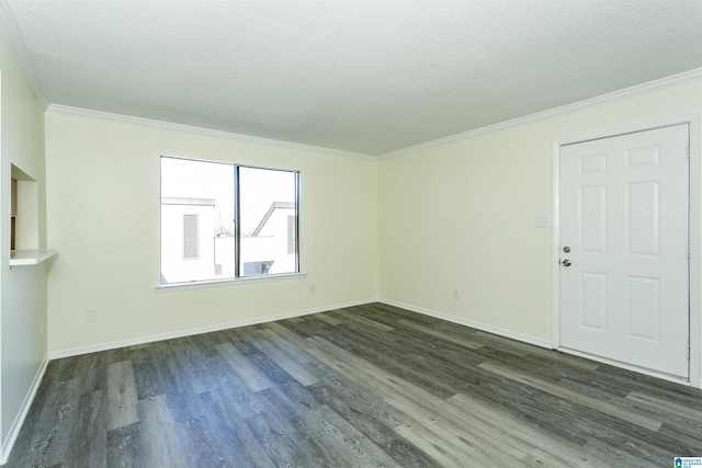 spare room featuring ornamental molding, dark hardwood / wood-style floors, and a textured ceiling