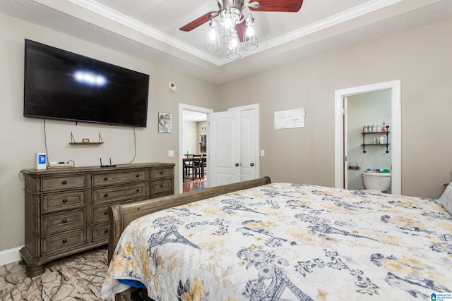 bedroom featuring a raised ceiling, ensuite bathroom, ornamental molding, and ceiling fan