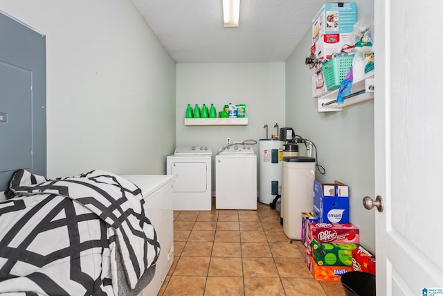 laundry room featuring washing machine and clothes dryer and light tile patterned floors