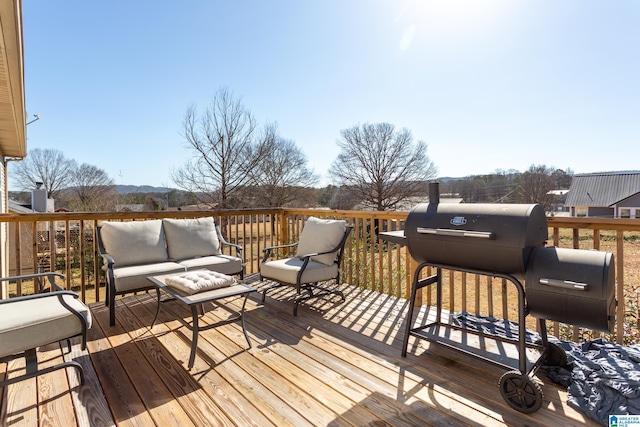 wooden terrace featuring grilling area and an outdoor hangout area