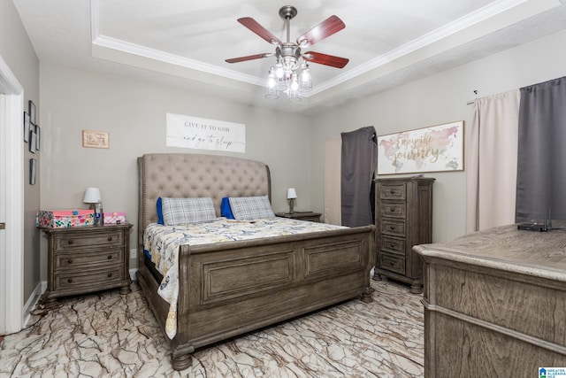 bedroom with ceiling fan, ornamental molding, and a tray ceiling