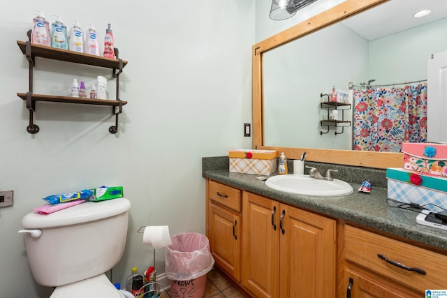 bathroom featuring vanity, toilet, curtained shower, and tile patterned flooring