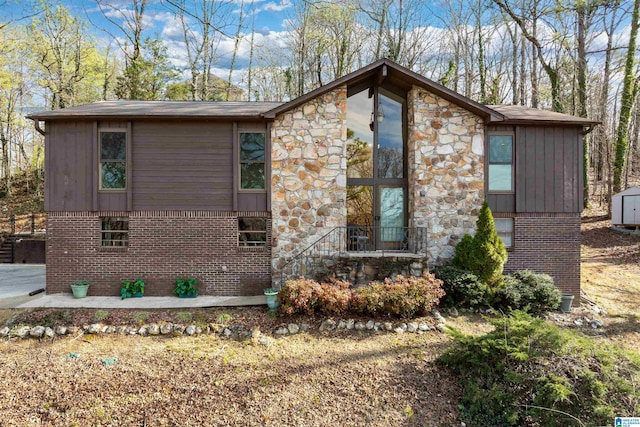 view of front of property with a storage shed