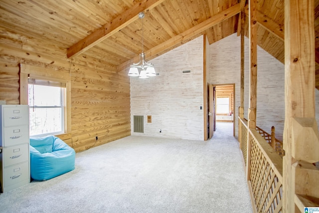 empty room featuring beam ceiling, wooden ceiling, and a healthy amount of sunlight