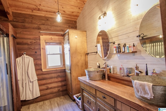 bathroom featuring lofted ceiling, rustic walls, wood ceiling, vanity, and hardwood / wood-style flooring