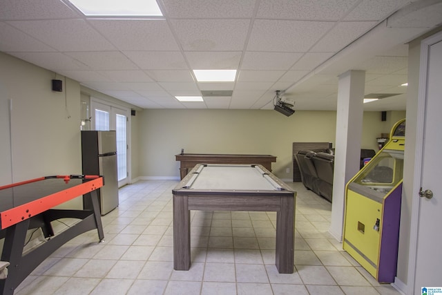 recreation room featuring french doors, pool table, light tile patterned floors, and a drop ceiling