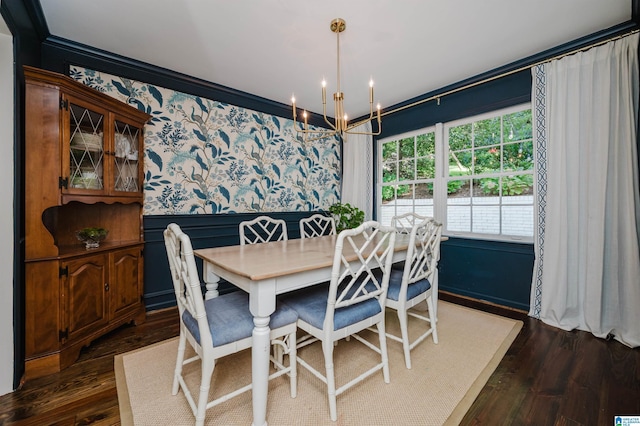 dining space with a notable chandelier, crown molding, and dark wood-type flooring