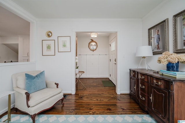 living area featuring crown molding and dark wood-type flooring