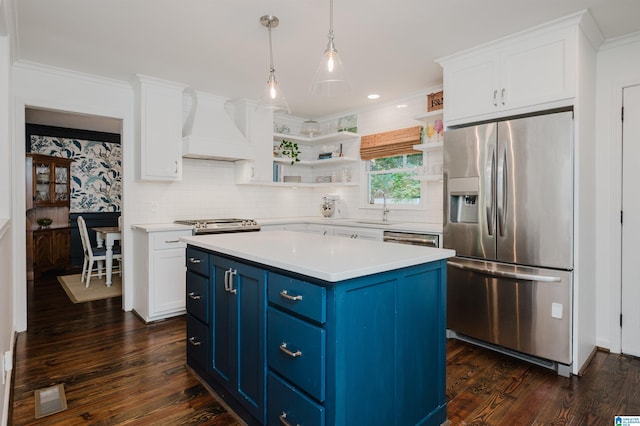 kitchen featuring blue cabinetry, custom exhaust hood, a center island, pendant lighting, and stainless steel appliances