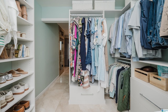 spacious closet featuring light tile patterned floors