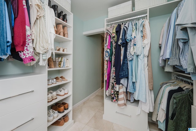 spacious closet with light tile patterned floors