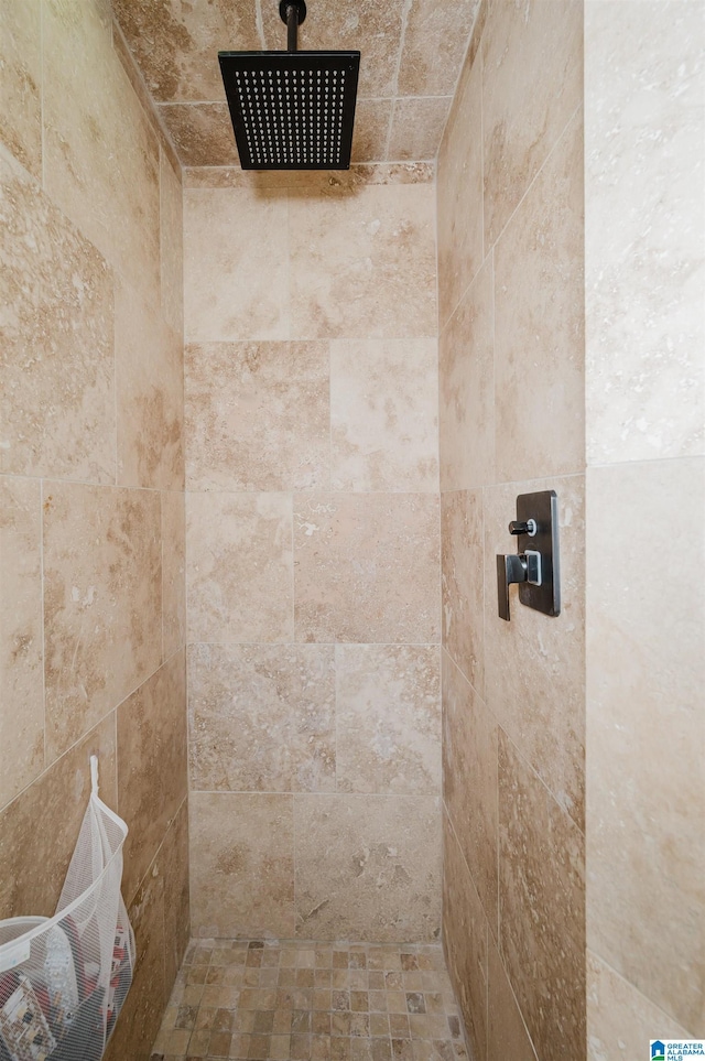 bathroom with tiled shower