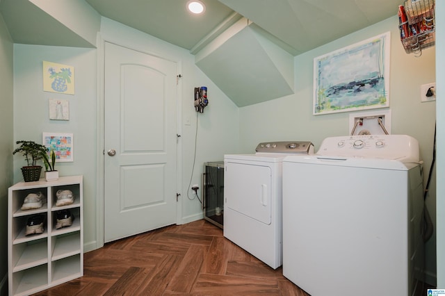 laundry room with washer and clothes dryer and dark parquet floors