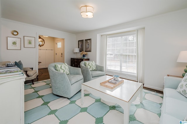 living room with ornamental molding and light hardwood / wood-style floors