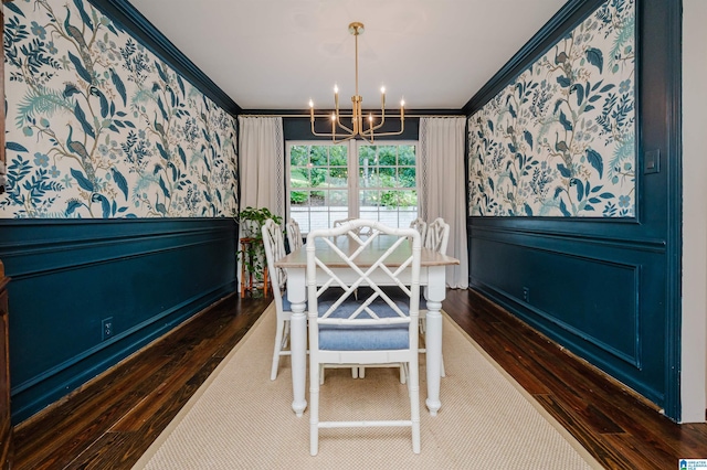 dining room featuring ornamental molding, dark hardwood / wood-style flooring, and a notable chandelier