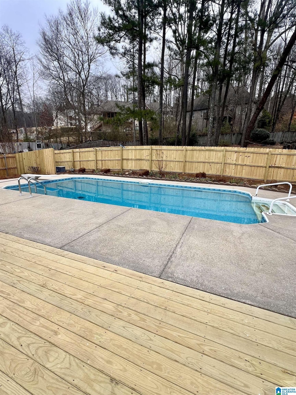 view of swimming pool featuring a wooden deck