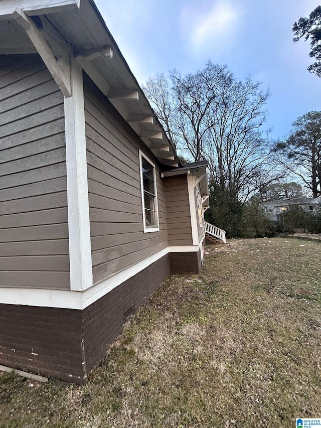 view of home's exterior with a yard