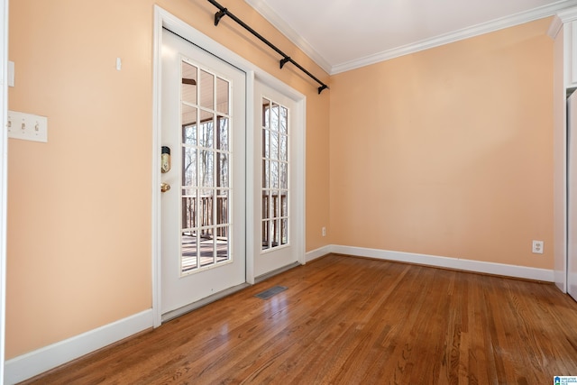 unfurnished room featuring hardwood / wood-style flooring and ornamental molding