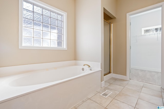 bathroom featuring tile patterned floors and separate shower and tub