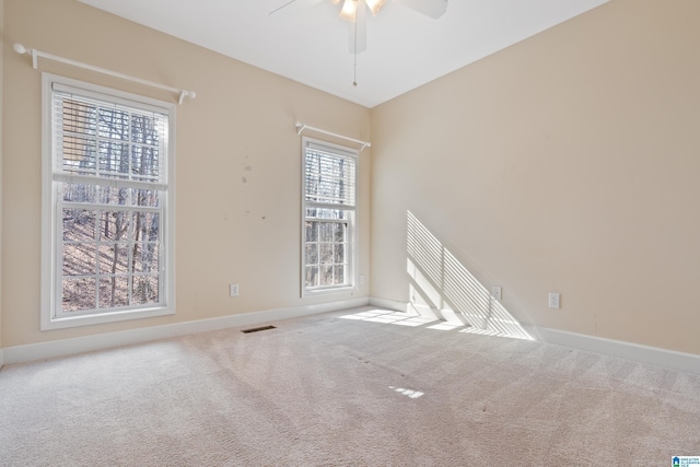 carpeted empty room with ceiling fan