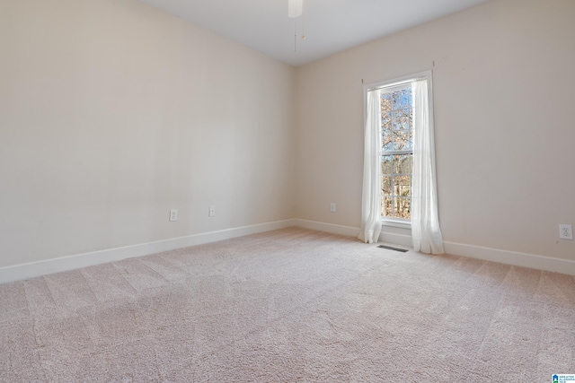 empty room featuring light carpet and ceiling fan