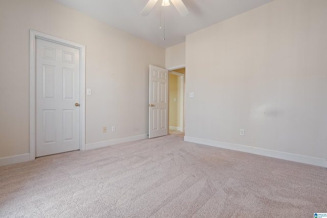 unfurnished room featuring light colored carpet and ceiling fan