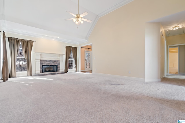 unfurnished living room with high vaulted ceiling, ornamental molding, a fireplace, and carpet floors