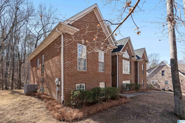 view of side of home featuring central AC unit