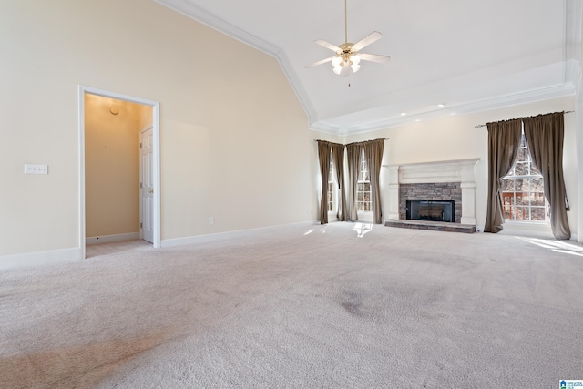 unfurnished living room featuring light carpet, crown molding, a stone fireplace, and high vaulted ceiling