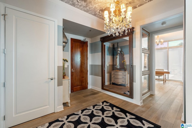 hall with a notable chandelier and light hardwood / wood-style flooring