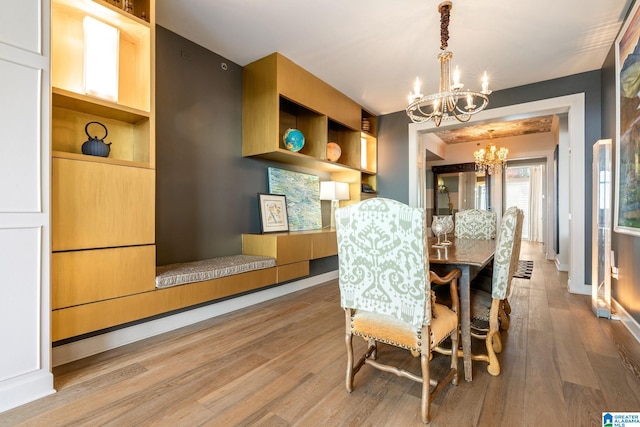 dining room with a notable chandelier and light hardwood / wood-style flooring