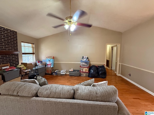 living room with ceiling fan, light wood-type flooring, and lofted ceiling