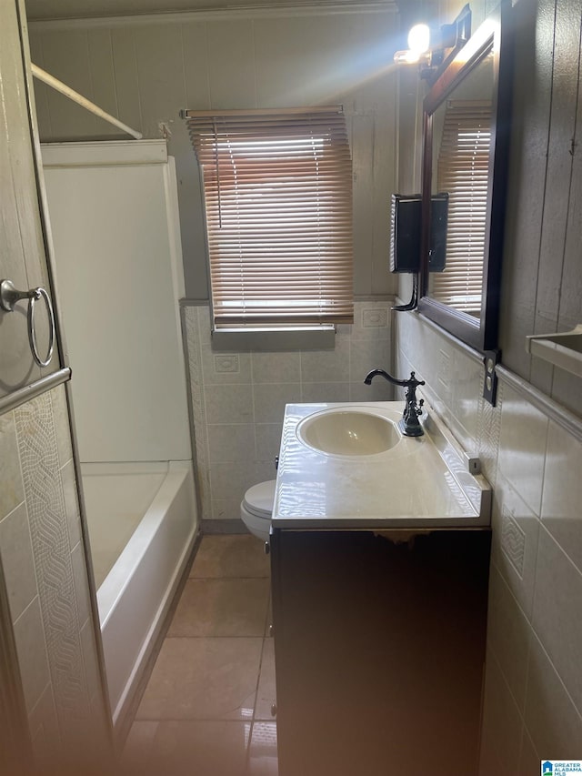 full bathroom featuring toilet, shower / bathing tub combination, tile walls, vanity, and tile patterned flooring