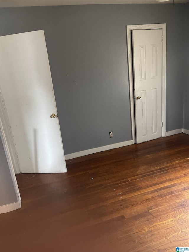 unfurnished room featuring dark hardwood / wood-style floors