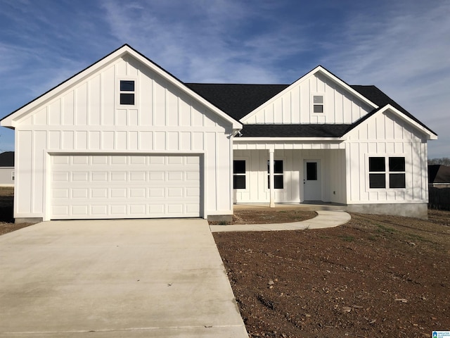 modern inspired farmhouse with a garage and a porch