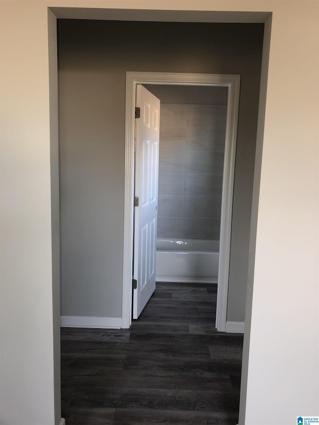 corridor featuring dark hardwood / wood-style floors