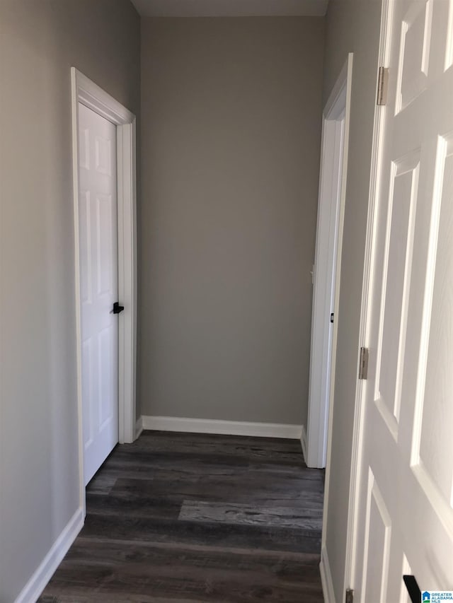 corridor with dark hardwood / wood-style floors