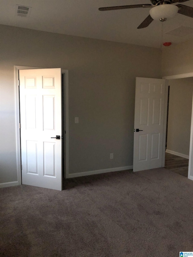 carpeted spare room featuring ceiling fan